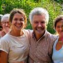 A vibrant community garden with diverse individuals happily interacting, representing community stories
